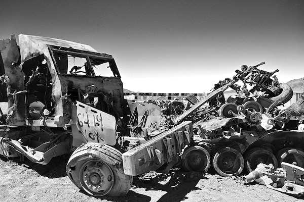 Mangled vehicles and shipping containers.