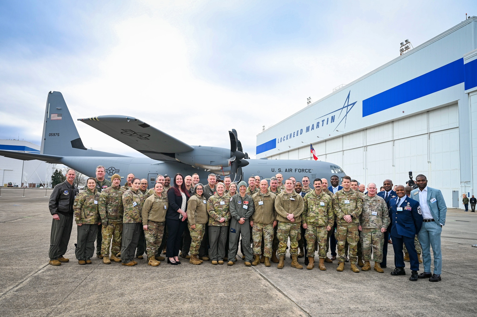 group of air force members in front of a new C-130J Super Hercules Aircraft