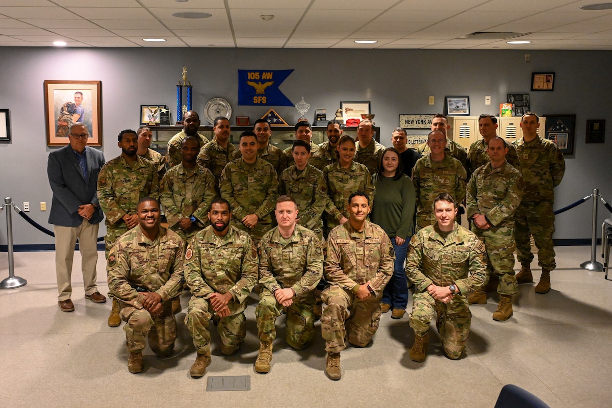 Graduates of an Instructor's Course pose in the Base Defense Group building.