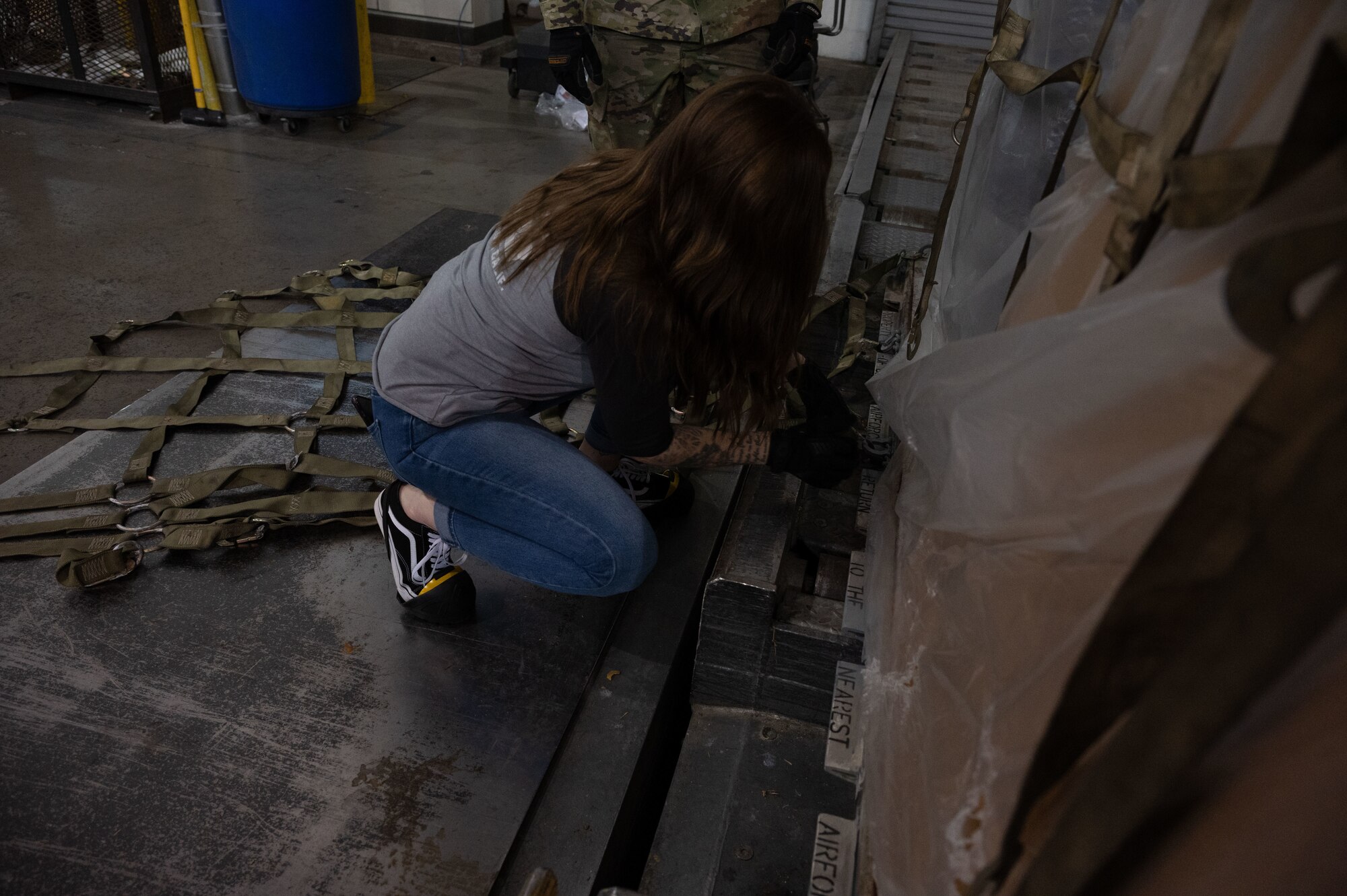 A Team Dover spouse hooks a net to a pallet during the 436th Aerial Port Squadron Spouse Immersion tour at Dover Air Force Base, Delaware, Jan. 26, 2024. The tour allowed spouses to learn and experience the different jobs within the “Super Port.” (U.S. Air Force photo by Airman 1st Class Dieondiere Jefferies)