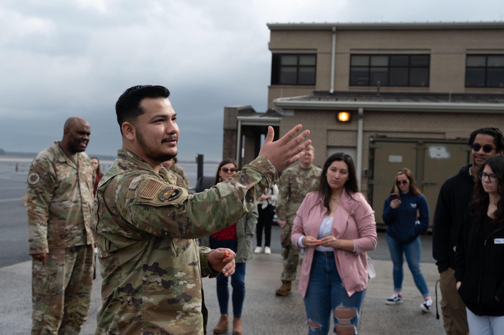 U.S. Air Force Senior Airman Joseph Rivera, 436th Aerial Port Squadron ramp services, explains what an aircraft cargo loader is during the 436th APS Spouse Immersion tour at Dover Air Force Base, Delaware, Jan. 26, 2024. The tour allowed spouses the opportunity to learn and experience the different jobs within the “Super Port.” (U.S. Air Force photo by Airman 1st Class Dieondiere Jefferies)