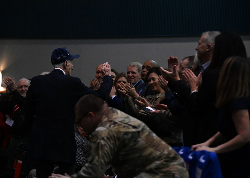 Man stands in front of standing ovation.