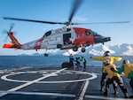 Crew members on USCGC Alex Haley (WMEC-39) conduct vertical replenishment training with the crew of an MH-60 Jayhawk helicopter from Air Station Kodiak in the Bering Sea Jan. 8, 2024. Haley's crew completed a 45-day patrol during which they conducted domestic fisheries enforcement, responded to search and rescue, and conducted several shipboard training exercises. (U.S. Coast Guard photo by Petty Officer 1st Class Jasen Newman)