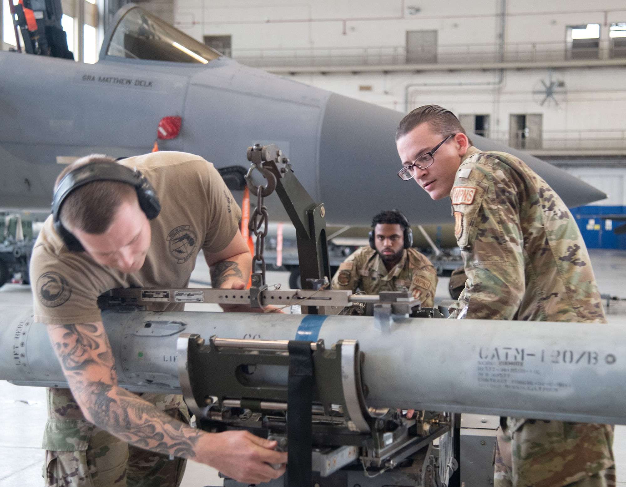 The 96th Aircraft Maintenance Squadron, Red team, weapons load crew work together to load the F-15 Eagle during the unit’s quarterly weapons load competition.