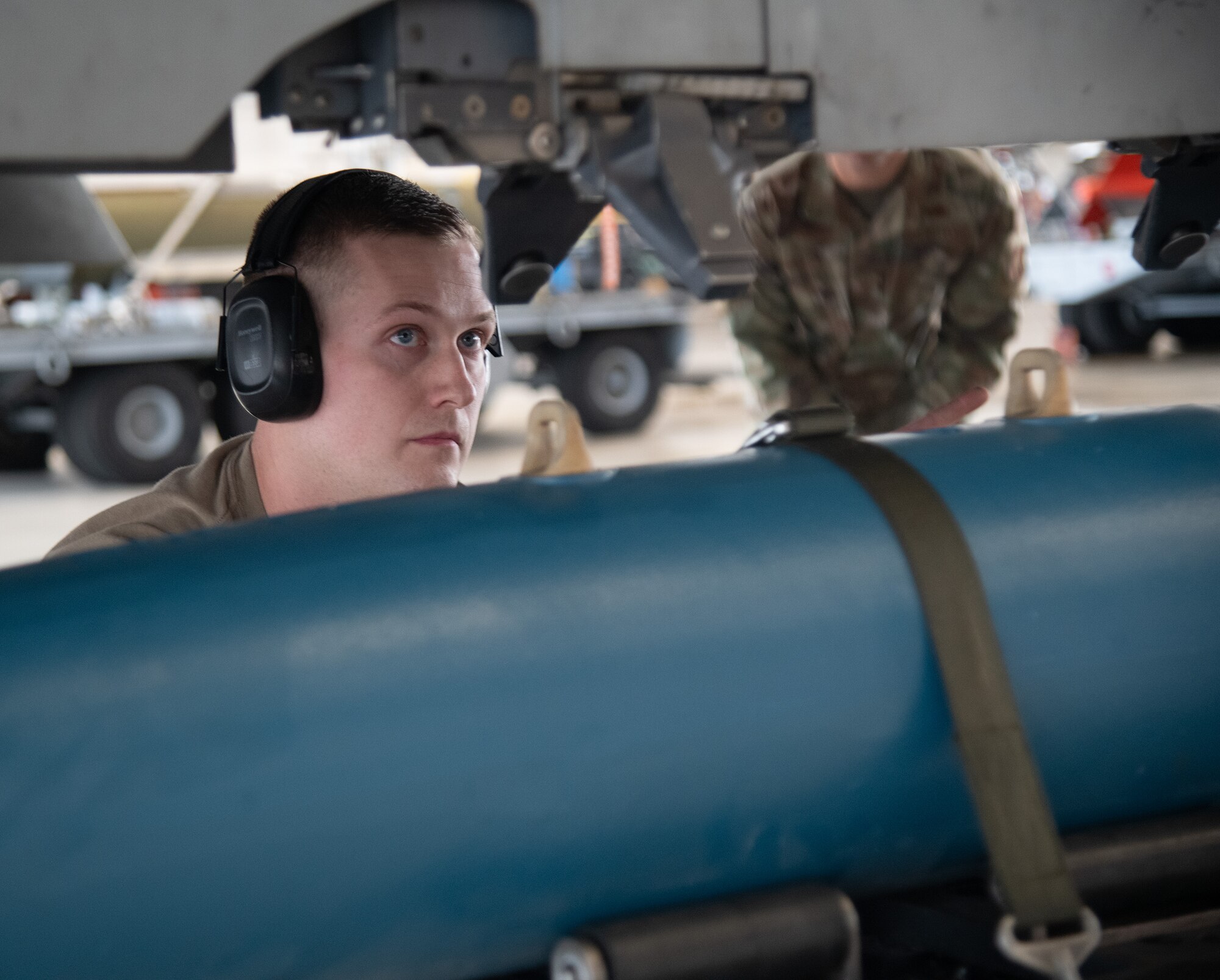 U.S. Air Force Staff Sgt. Kurt Walder, 96th Aircraft Maintenance Squadron load crew team chief, loads a GBU-38 bomb onto the F-15 Eagle’s weapons station.