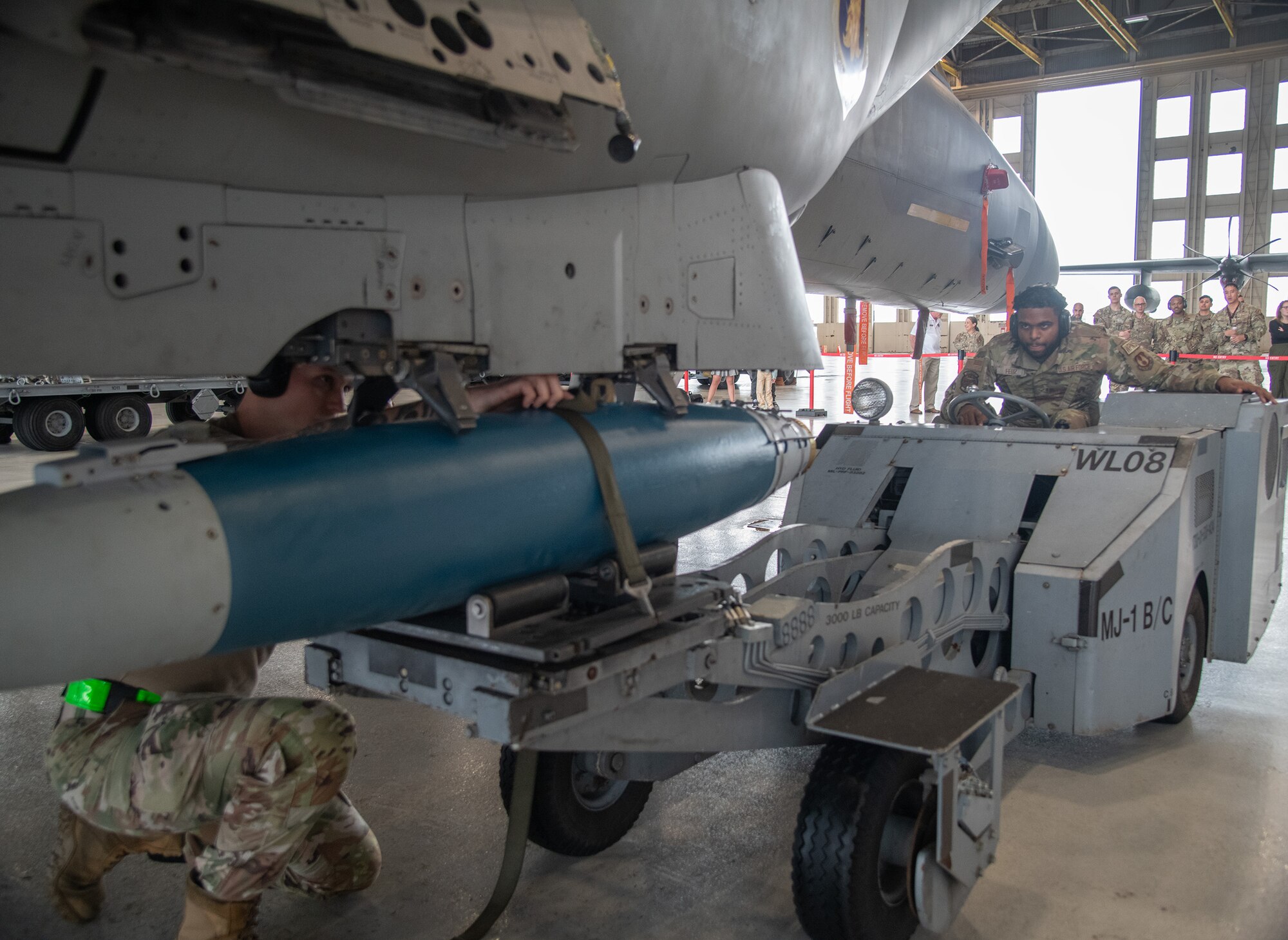 U.S. Air Force Staff Sgt. Kurt Walder (left) and Senior Airman Ronald Feliz, 96th Aircraft Maintenance Squadron weapons load crew Red team, lock in a GBU-38 bomb to the F-15 Eagle.