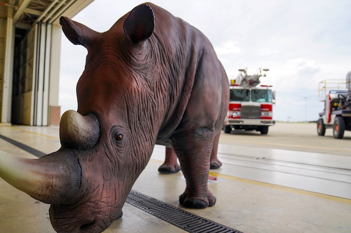 A rhinoceros statue is photographed in front of 9th Civil Engineer Squadron vehicles at the late Calvin Hendrix, 9th CES deputy commander memorial ceremony Jan. 19, 2024, at Beale Air Force Base, California.