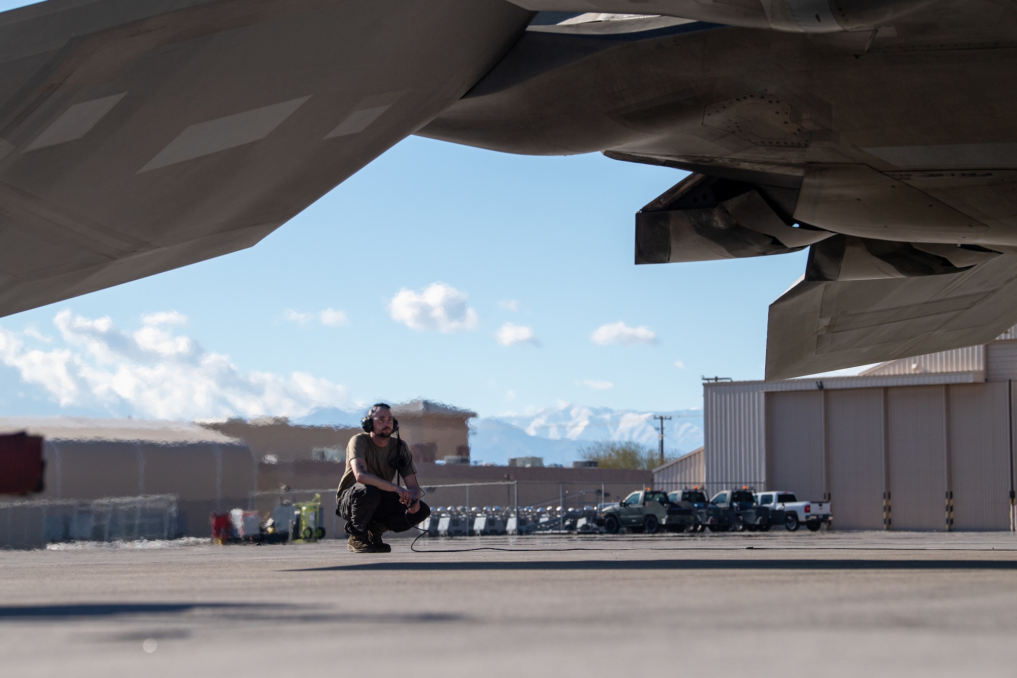 U.S. Air Force Airman First Class Jacob Upton, an assistant dedicated crew chief with the 525th Expeditionary Fighter Generation Squadron, Joint Base Elmendorf-Richardson, Alaska, inspects an F-22 Raptor prior to flight in support of Exercise Bamboo Eagle 24-1 at Nellis Air Force Base, Nevada, Jan. 25, 2024.