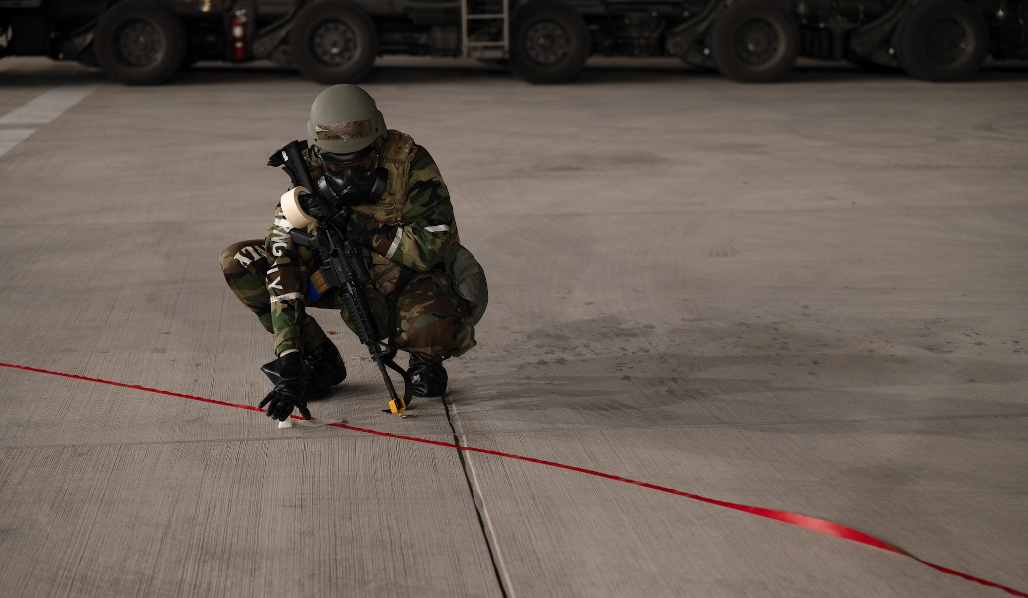 U.S. Air Force Airman 1st Class Candace Yates, 731st Air Mobility Squadron passenger service representative, cordons off a simulated unexploded ordnance during Beverly Midnight 24-1 at Osan Air Base, Republic of Korea, Jan. 30, 2024. As the most forward deployed permanently based wing in the Air Force, the 51st Fighter Wing is charged with providing mission-ready Airmen to execute combat operations and receive follow-on forces. BM24 is a routine training event that tests the military capabilities across the peninsula, allowing combined and joint training at both the operational and tactical levels. (U.S. Air Force photo by Senior Airman Brittany Russell)