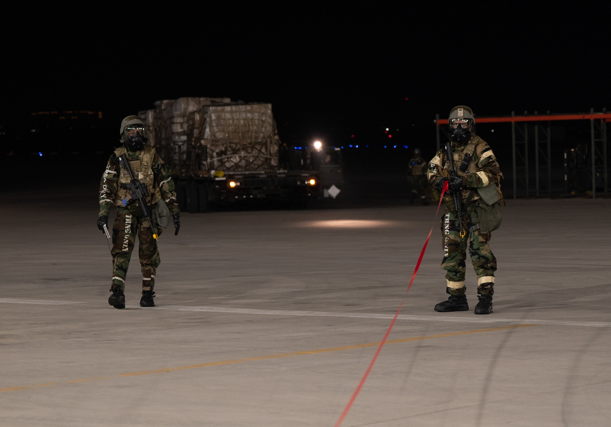 U.S. Air Force Airman 1st Class Candace Yates, left, and Airman Gavyn Hinojosa, 731st Air Mobility Squadron passenger service representatives, cordon off a simulated unexploded ordnance during Beverly Midnight 24-1 at Osan Air Base, Republic of Korea, Jan. 30, 2024. Cordoning a UXO is done to establish a perimeter around the danger area. As the most forward deployed permanently based wing in the Air Force, the 51st Fighter Wing is charged with providing mission-ready Airmen to execute combat operations and receive follow-on forces. BM24-1 is a routine training event that tests the military capabilities across the peninsula, allowing combined and joint training at both the operational and tactical levels. (U.S. Air Force photo by Senior Airman Brittany Russell)
