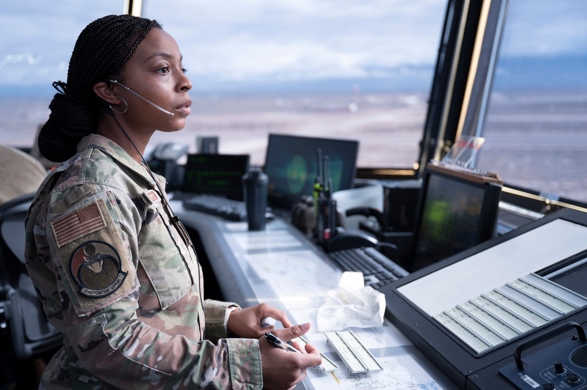 U.S. Air Force Airman 1st Class Indya Wiggins, 54th Operations Support Squadron air traffic controller, scans the runway for taxiway activity, at Holloman Air Force Base, New Mexico, Jan. 24, 2024. Air traffic controllers operate air traffic systems to expedite the flow of all inbound and outbound aircraft on base. (U.S. Air Force photo by Airman 1st Class Michelle Ferrari)