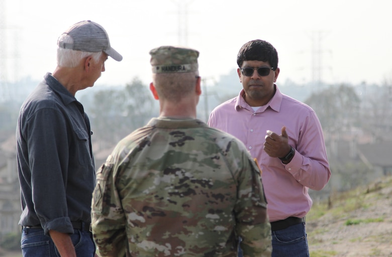 George Sunny, U.S. Army Corps of Engineers Los Angeles District project manager, right, joins Doug Chitwood, LA District lead project engineer, left, in providing project updates to Col. James Handura, commander of the Corps’ South Pacific Division, during a site tour Jan. 18 on the Rio Hondo side of Whittier Narrows Dam in Montebello, California.