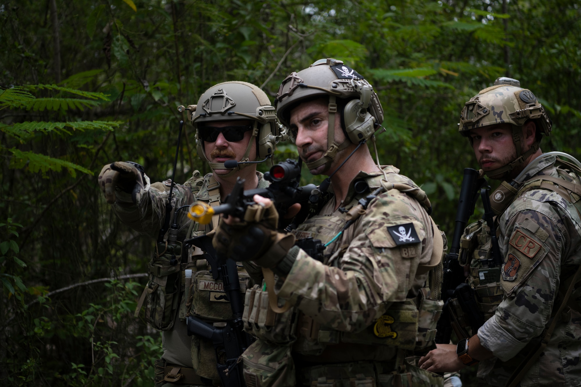 From left, U.S. Air Force Master Sgt. Joshua McConnel, a security forces craftsman, and Staff Sgt. Yuri Motamedi, a security forces craftsman, both with the 123rd Contingency Response Group, Kentucky Air National Guard, and Senior Airman Kevin Medina, a security forces journeyman with the 156th Security Operations Squadron, Puerto Rico Air National Guard, communicate during air base ground defense training at Muñiz Air National Guard Base in Carolina, Puerto Rico, Sept. 21, 2023. During the training, Airmen reinforced air base ground defense skills utilized during contingency response operations in contested environments by practicing radio communications, warning and operation orders, vehicle searches, vehicle take-downs, close-quarter battle, and small team tactics. (U.S. Air National Guard photo by Master Sgt. Rafael D. Rosa)