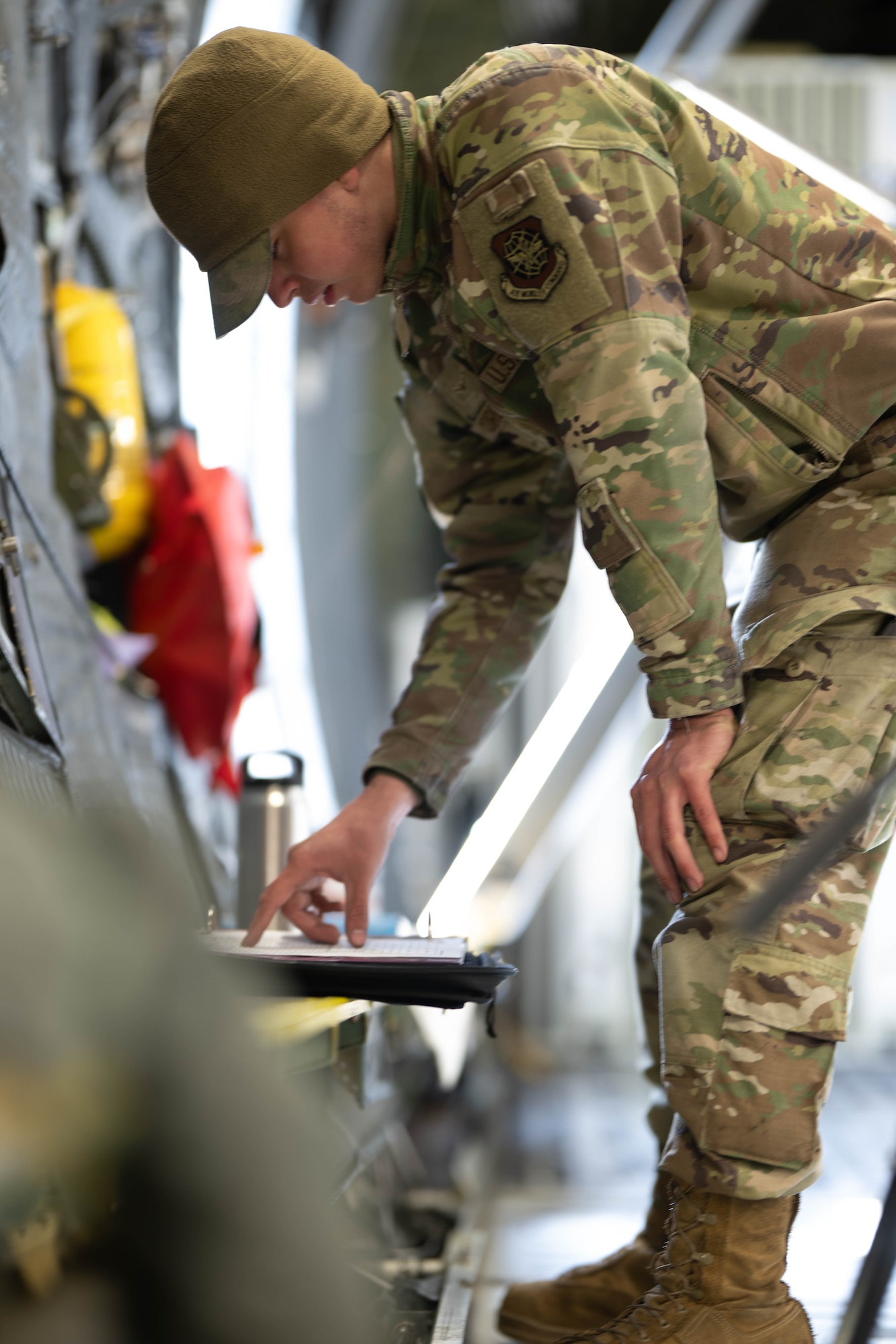 U.S. Air Force Airman Pablo Corona, 436th Aircraft Maintenance Squadron crew chief reviews vitals during a Fleet Launch Under Severe Hazards exercise at Dover Air Force Base, Delaware, Jan. 29, 2024. The C-5M FLUSH checklist was designed for an aircrew to launch the Super Galaxy from a ‘no power on’ or ‘dark’ status to an all four engines running posture and taxiing off the parking spot in minimal amount of time for departure in case of an imminent threat. (U.S. Air Force photo by Mauricio Campino)