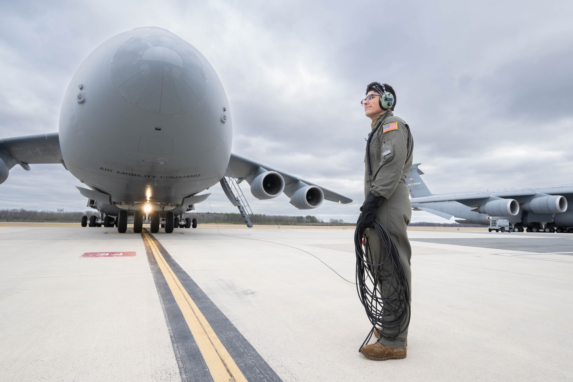 U.S. Air Force Staff Sgt. Shen Knoll, 9th Airlift Squadron flight engineer clears flaps on a C-5M Super Galaxy during a Fleet Launch Under Severe Hazards exercise at Dover Air Force Base, Delaware, Jan. 29, 2024. The C-5M FLUSH checklist was designed for an aircrew to launch the Super Galaxy from a ‘no power on’ or ‘dark’ status to an all four engines running posture and taxiing off the parking spot in minimal amount of time for departure in case of an imminent threat. (U.S. Air Force photo by Mauricio Campino)