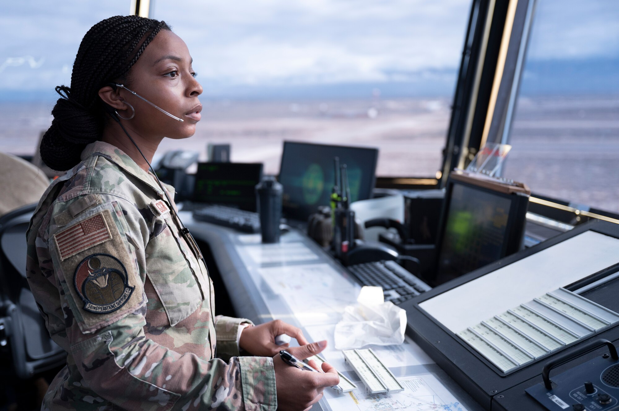 U.S. Air Force Airman 1st Class Indya Wiggins, 54th Operations Support Squadron air traffic controller, scans the runway for taxiway activity, at Holloman Air Force Base, New Mexico, Jan. 24, 2024. Air traffic controllers operate air traffic systems to expedite the flow of all inbound and outbound aircraft on base. (U.S. Air Force photo by Airman 1st Class Michelle Ferrari)