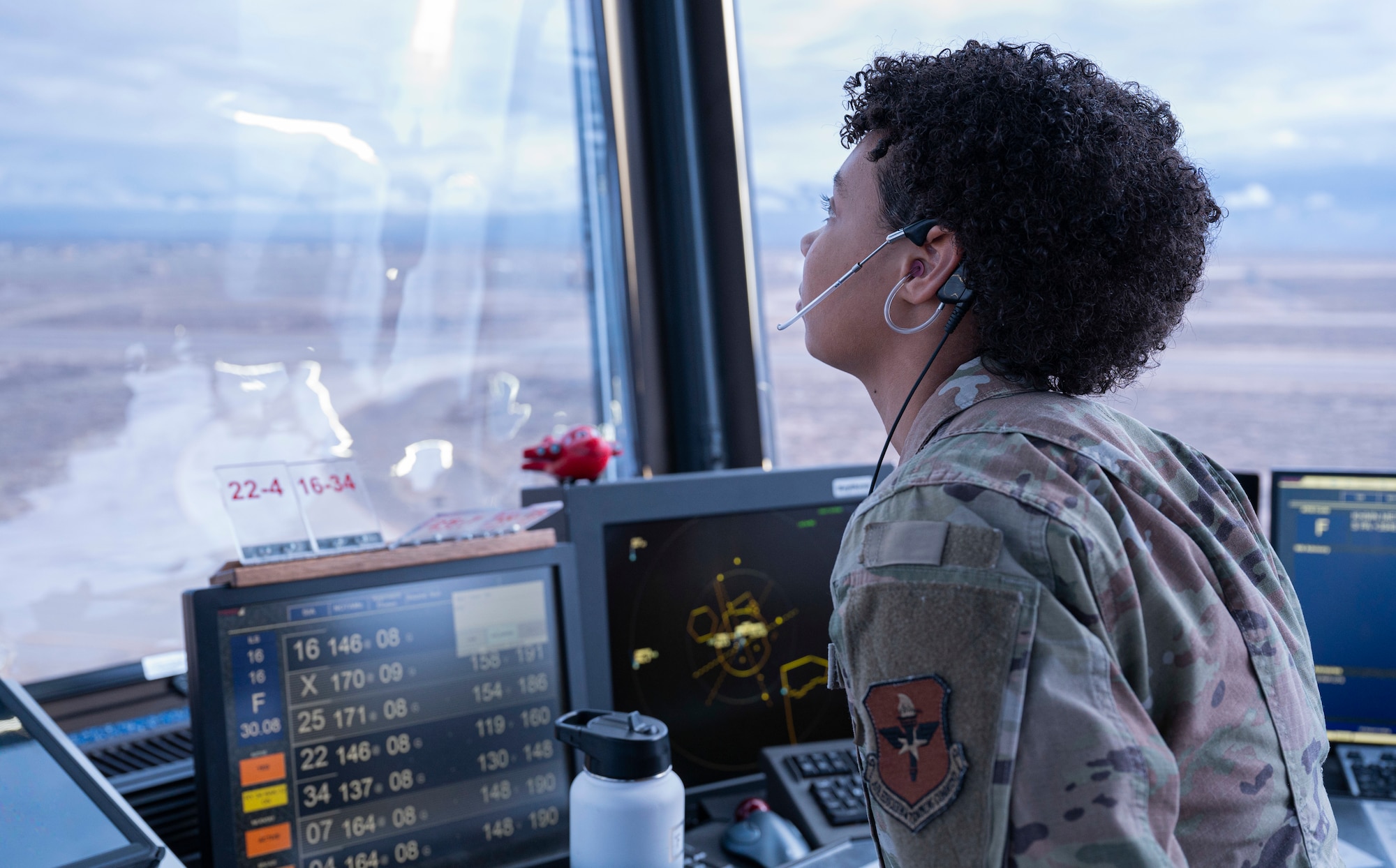 U.S. Air Force Airman 1st Class Alexis King, 54th Operations Support Squadron air traffic controller, monitors taxiway activity from the air traffic tower, at Holloman Air Force Base, New Mexico, Jan. 24, 2024. ATC Airmen play a significant role in communicating fight patterns, weather information and are responsible for clearing pilots during take-off and landing. (U.S. Air Force photo by Airman 1st Class Michelle Ferrari)