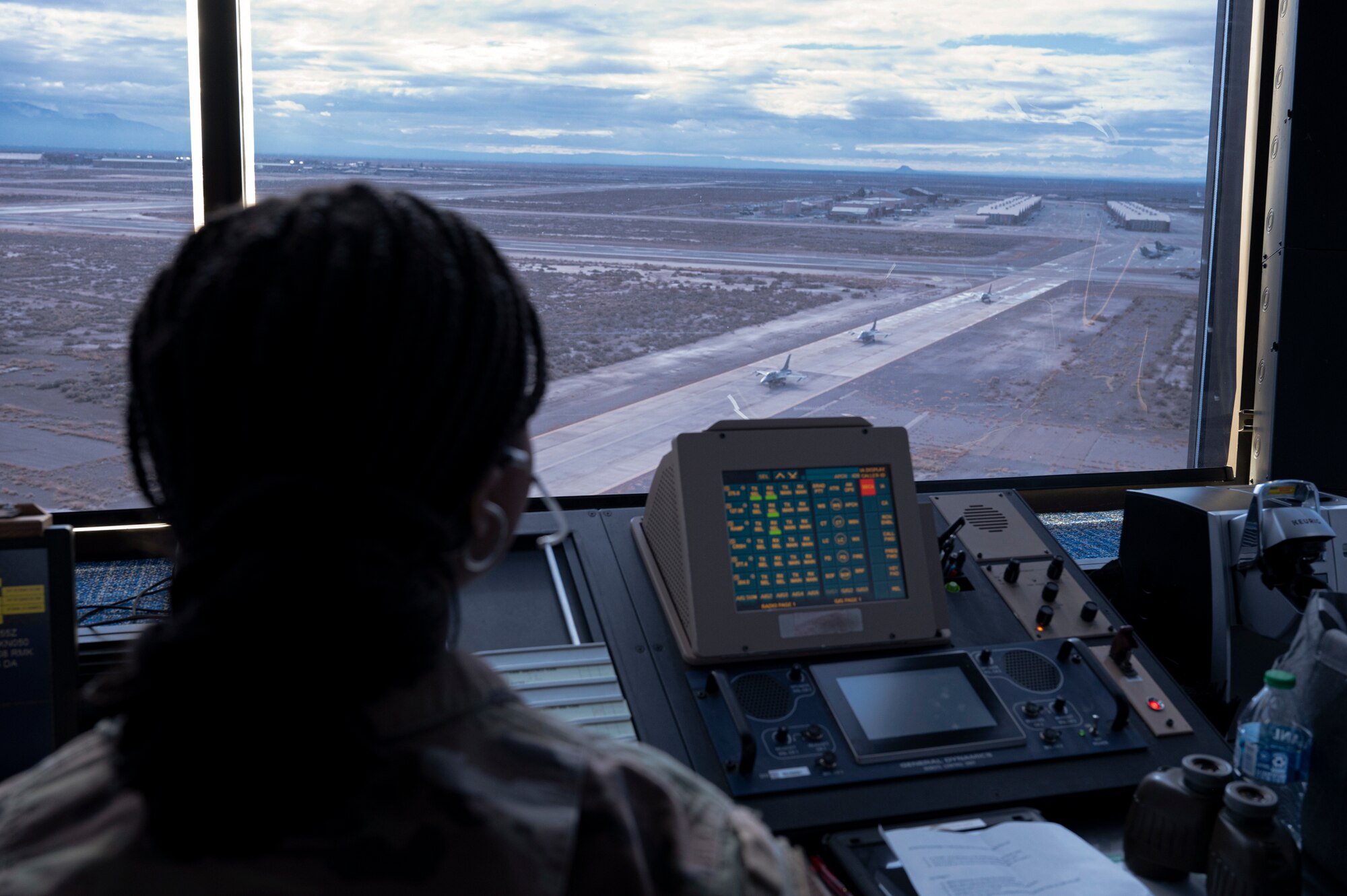 U.S. Air Force Airman 1st Class Indya Wiggins, 54th Operations Support Squadron air traffic controller, monitors the taxiway activity from the air traffic tower, at Holloman Air Force Base, New Mexico, Jan. 24, 2024. Air traffic controllers operate air traffic systems to expedite the flow of all inbound and outbound aircraft on base. (U.S. Air Force photo by Airman 1st Class Michelle Ferrari)