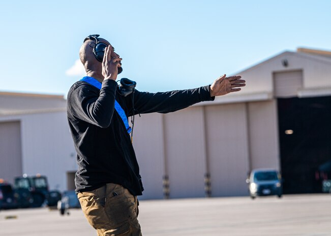 U.S. Air Force Airman First Class Kawan Thornton, a crew chief with the 525th Expeditionary Fighter Generation Squadron, Joint Base Elmendorf-Richardson, Alaska, marshals an F-22 Raptor assigned to the 525th Expeditionary Fighter Squadron in support of Exercise Bamboo Eagle 24-1 at Nellis Air Force Base, Nevada, Jan. 25, 2024.