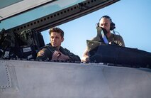 U.S. Air Force 1st Lt. Jake Heydinger, a pilot with the 525th Expeditionary Fighter Squadron, Joint Base Elmendorf-Richardson, Alaska, and U.S. Air Force Airman First Class Jacob Upton, an assistant dedicated crew chief with the 525th Expeditionary Fighter Generation Squadron, watch an aircraft launch prior to flight in support of Exercise Bamboo Eagle 24-1 at Nellis Air Force Base, Nevada, Jan. 25, 2024.