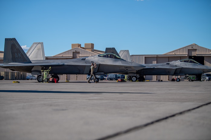 Two F-22 Raptors assigned to the 525th Expeditionary Fighter Squadron, Joint Base Elmendorf-Richardson, Alaska, prepare for takeoff in support of Exercise Bamboo Eagle 24-1 at Nellis Air Force Base, Nevada, Jan. 25, 2024.