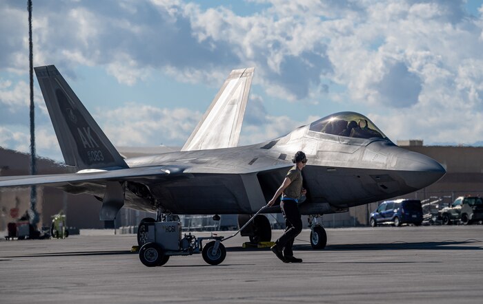A U.S. Air Force Airman assigned to the 525th Expeditionary Fighter Generation Squadron, Joint Base Elmendorf-Richardson, Alaska, concludes maintenance on an F-22 Raptor assigned to the 525th Expeditionary Fighter Squadron in support of Exercise Bamboo Eagle 24-1 at Nellis Air Force Base, Nevada, Jan. 25. 2024.