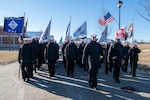 Navy recruits march in formation.