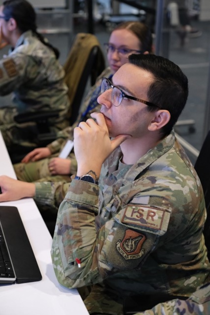photo of a uniformed military member working on computer