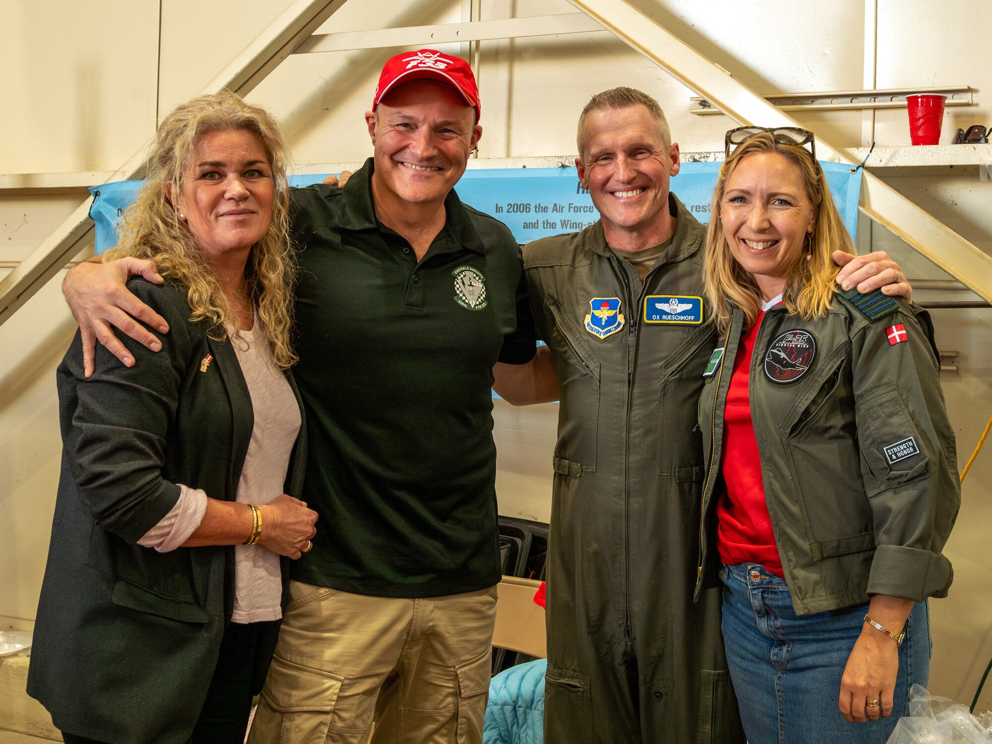 U.S. Air Force Brig. Gen. Jason Rueschhoff (center right), 56th Fighter Wing commander, poses with members and military spouses from the Danish Detachment attached to the 308th Fighter Squadron during the Luke Air Force Base International Festival 2024, Jan 26, 2024, at Luke AFB, Arizona.