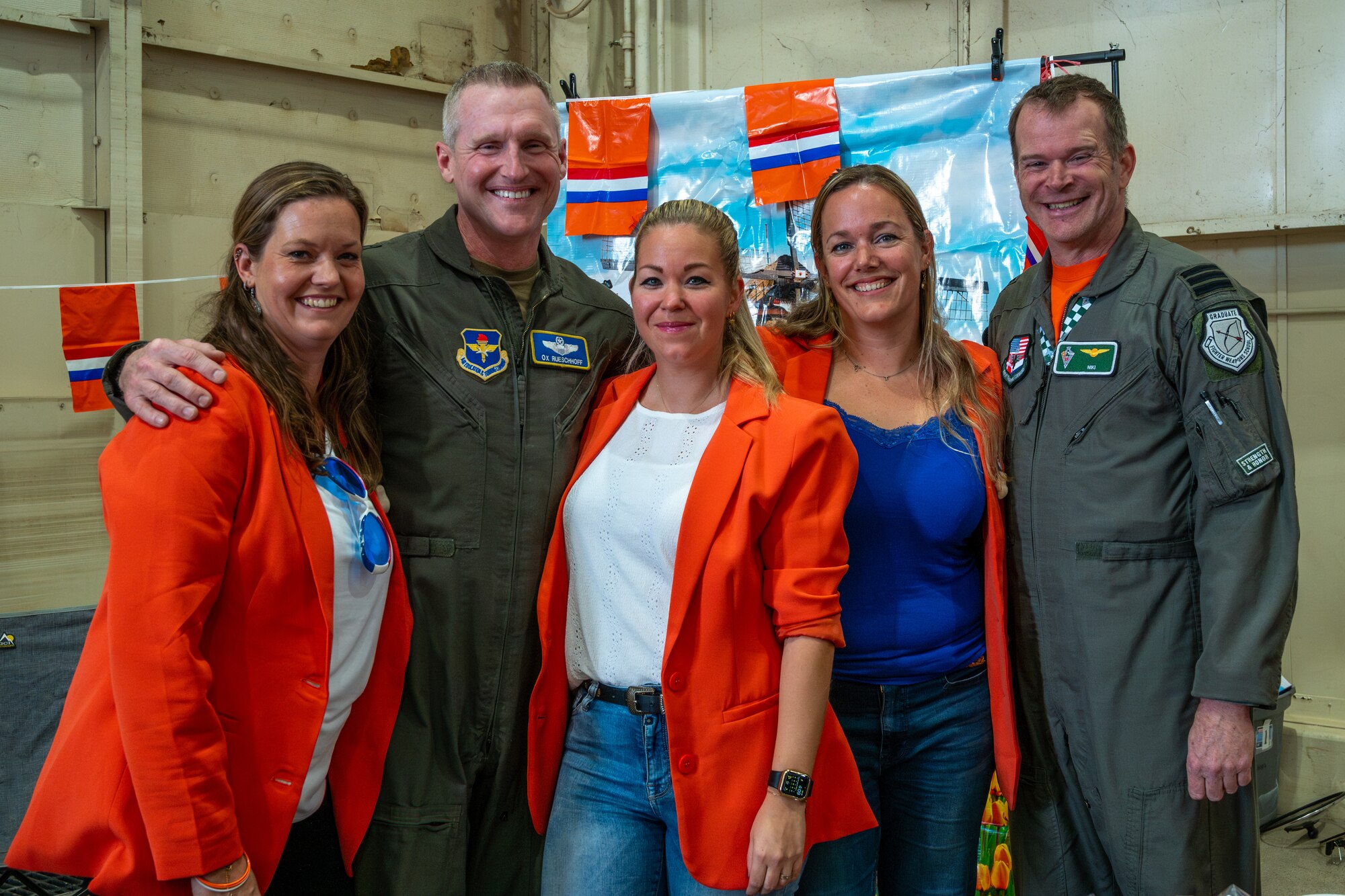 U.S. Air Force Brig. Gen. Jason Rueschhoff (center left), 56th Fighter Wing commander, poses with a pilot and military spouses from the Royal Netherland’s Air Force F-35 Training Detachment attached to the 308th Fighter Squadron during the Luke Air Force Base International Festival 2024, Jan 26, 2024, at Luke AFB, Arizona.