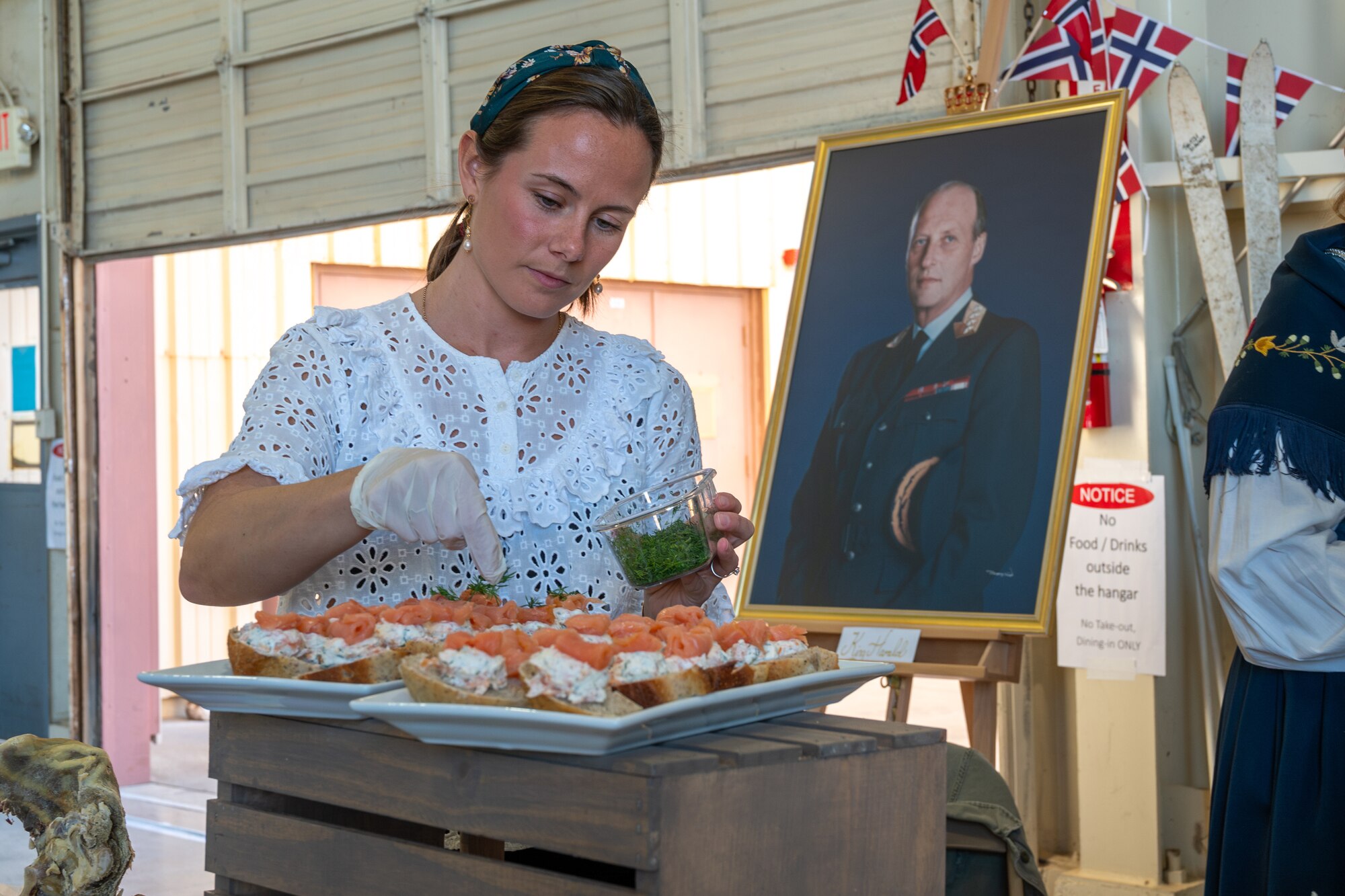 Tonje Fredriksen, a military spouse with the Norwegian F-35 Detachment attached to the 308th Fighter Squadron, prepares traditional food at a booth during the Luke Air Force Base International Festival 2024, Jan 26, 2024, at Luke AFB, Arizona.