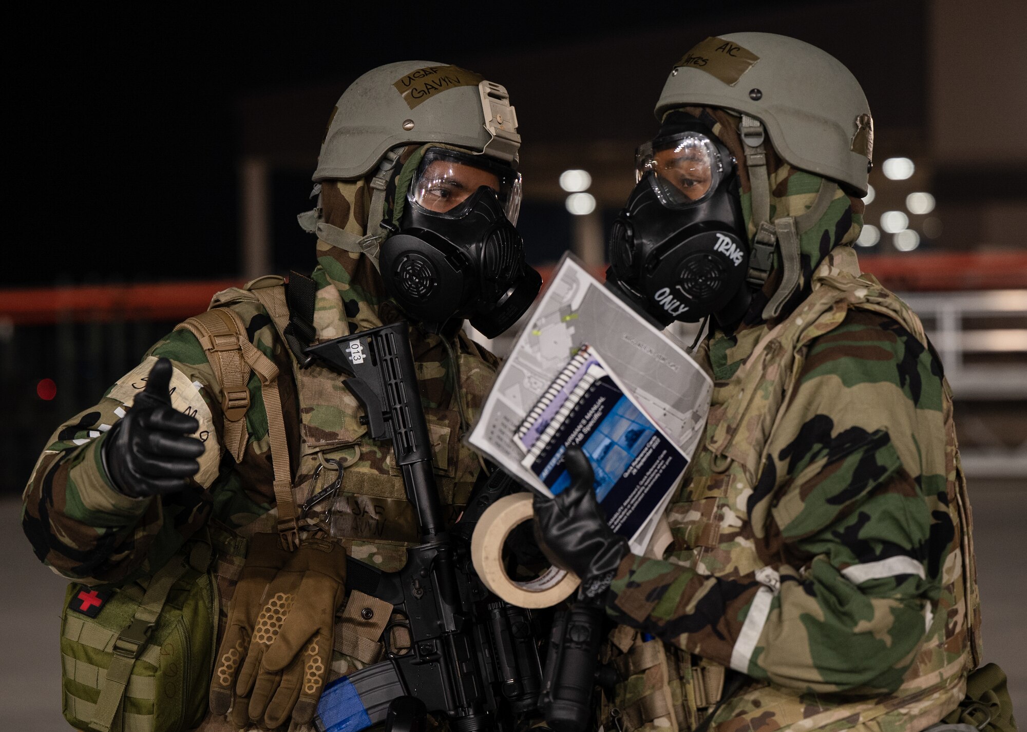 U.S. Air Force Airman Gavyn Hinojosa, left, and Airman 1st Class Candace Yates, 731st Air Mobility Squadron passenger service representatives, assess and discuss simulated damage to infrastructure from an unexploded ordnance during Beverly Midnight 24-1 at Osan Air Base, Republic of Korea, Jan. 30, 2024. The Airmen of the 51st Fighter Wing continuously train to maintain the high level of full-spectrum readiness required to execute the mission proficiently and effectively. BM24-1 is a routine training event that tests the military capabilities across the peninsula, allowing combined and joint training at both the operational and tactical levels. (U.S. Air Force photo by Senior Airman Brittany Russell)