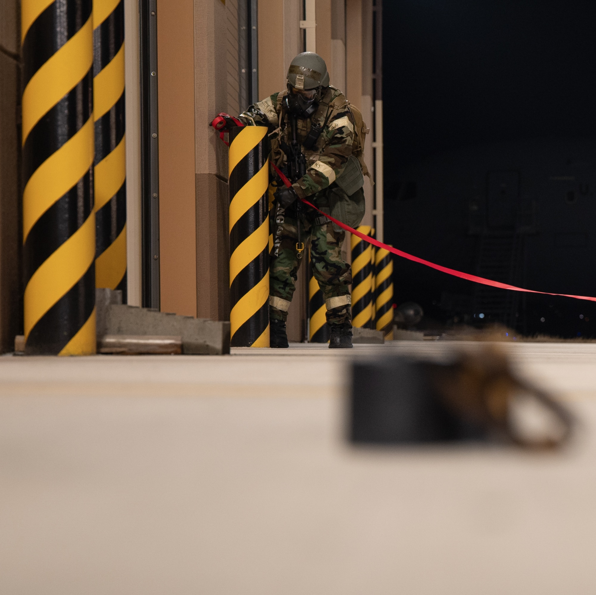 U.S. Air Force Airman Gavyn Hinojosa, 731st Air Mobility Squadron passenger service representative, cordons off a simulated unexploded ordnance during Beverly Midnight 24-1 at Osan Air Base, Republic of Korea, Jan. 30, 2024. As the most forward deployed permanently based wing in the Air Force, the 51st Fighter Wing is charged with providing mission-ready Airmen to execute combat operations and receive follow-on forces. BM24-1 is a routine training event that tests the military capabilities across the peninsula, allowing combined and joint training at both the operational and tactical levels. (U.S. Air Force photo by Senior Airman Brittany Russell)