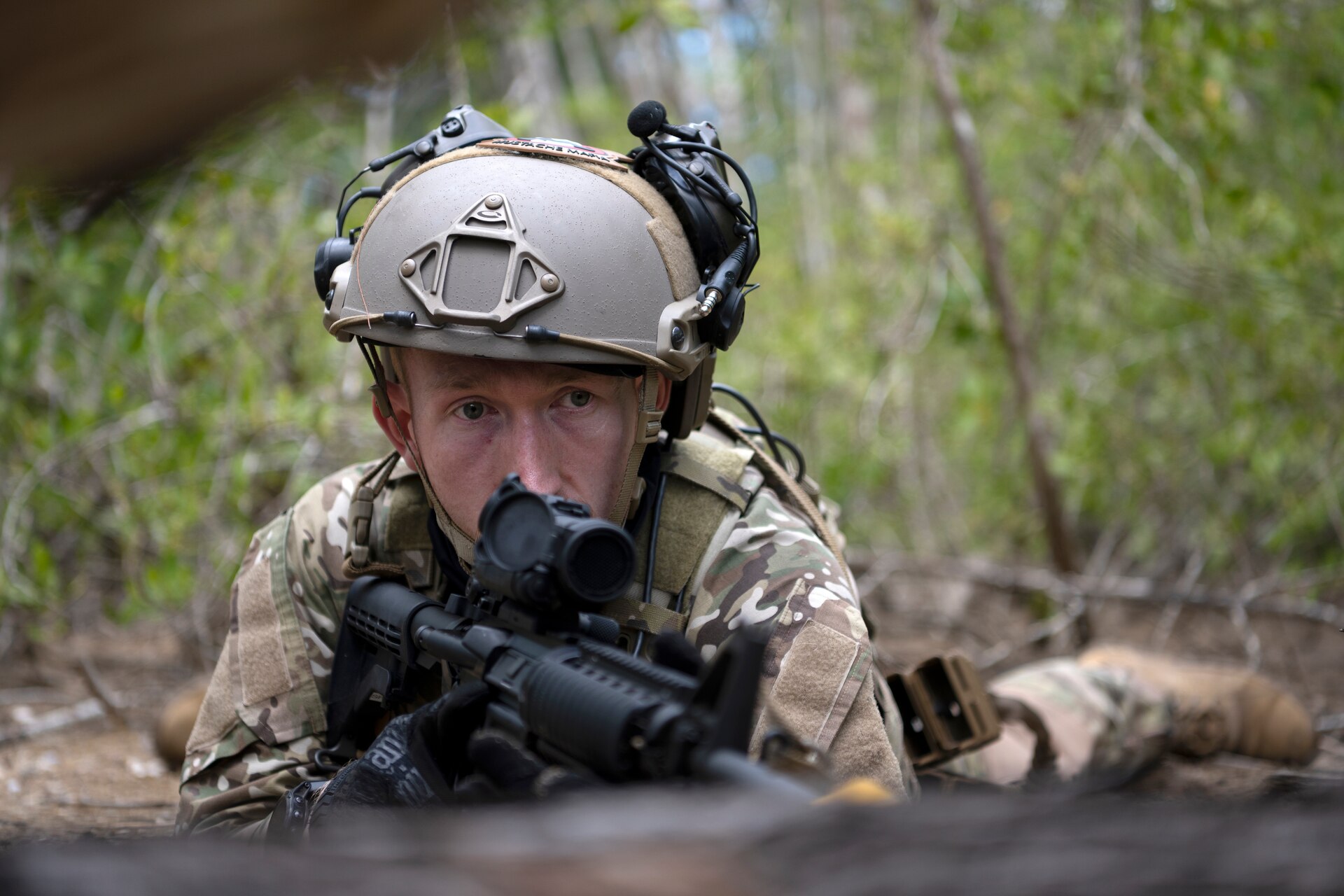 U.S. Air Force Senior Airman Tyler McCauley, a security forces journeyman with the 123rd Contingency Response Group, Kentucky Air National Guard, assumes a prone position during air base ground defense training at Muñiz Air National Guard Base in Carolina, Puerto Rico, Sept. 21, 2023. During the training, Airmen reinforced air base ground defense skills utilized during contingency response operations in contested environments by practicing radio communications, warning and operation orders, vehicle searches, vehicle take-downs, close-quarter battle, and small team tactics. (U.S. Air National Guard photo by Master Sgt. Rafael D. Rosa)