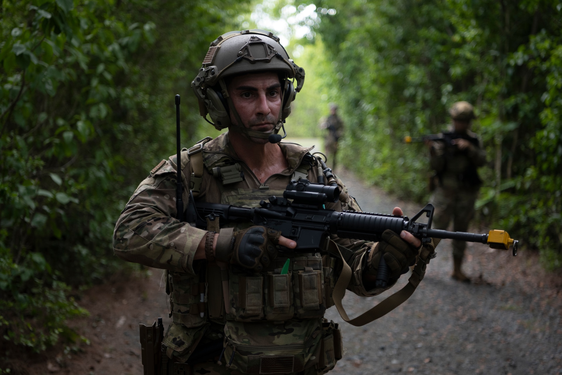 U.S. Air Force Staff Sgt. Yuri Motamedi, a security forces craftsman with the 123rd Contingency Response Group, Kentucky Air National Guard, and Airmen assigned to the Puerto Rico and Kentucky Air National Guard patrol a trail during air base ground defense training at Muñiz Air National Guard Base in Carolina, Puerto Rico, Sept. 21, 2023. During the training, Airmen reinforced air base ground defense skills utilized during contingency response operations in contested environments by practicing radio communications, warning and operation orders, vehicle searches, vehicle take-downs, close-quarter battle, and small team tactics. (U.S. Air National Guard photo by Master Sgt. Rafael D. Rosa)