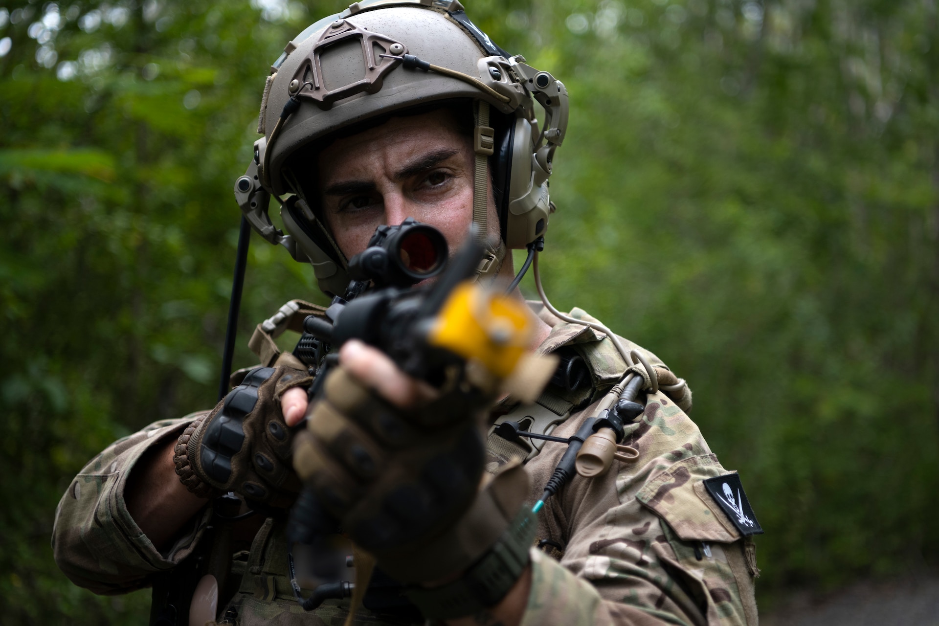 U.S. Air Force Staff Sgt. Yuri Motamedi, a security forces craftsman with the 123rd Contingency Response Group, Kentucky Air National Guard, aims his weapon during air base ground defense training at Muñiz Air National Guard Base in Carolina, Puerto Rico, Sept. 21, 2023. During the training, Airmen reinforced air base ground defense skills utilized during contingency response operations in contested environments by practicing radio communications, warning and operation orders, vehicle searches, vehicle take-downs, close-quarter battle, and small team tactics. (U.S. Air National Guard photo by Master Sgt. Rafael D. Rosa)