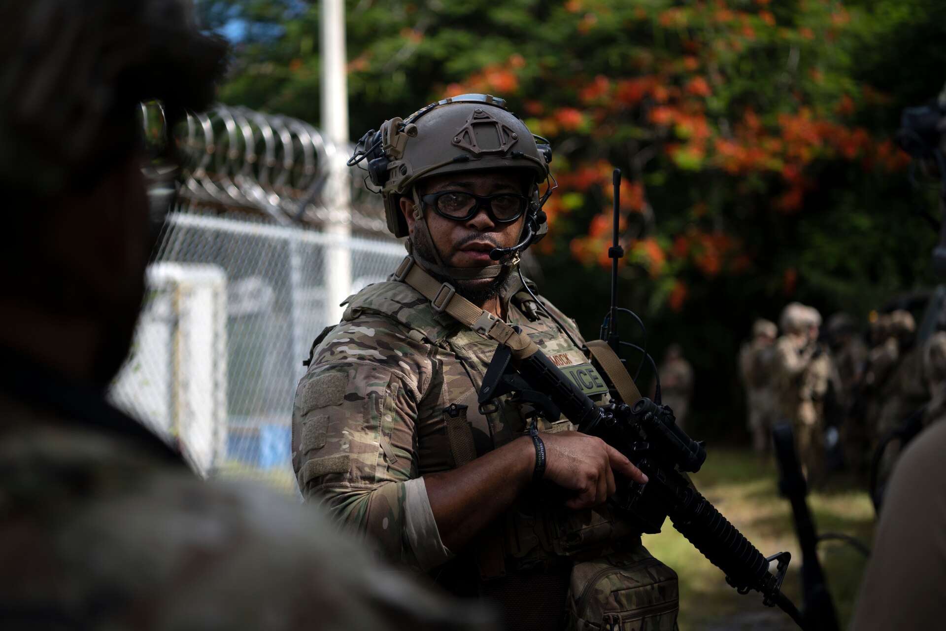 U.S. Air Force Tech. Sgt. Remy Hammock, a security forces craftsman with the 123rd Contingency Response Group, Kentucky Air National Guard, relays the squad leader’s instruction to his team prior to starting air base ground defense training at Muñiz Air National Guard Base in Carolina, Puerto Rico, Sept. 21, 2023. During the training, Airmen reinforced air base ground defense skills utilized during contingency response operations in contested environments by practicing radio communications, warning and operation orders, vehicle searches, vehicle take-downs, close-quarter battle, and small team tactics. (U.S. Air National Guard photo by Master Sgt. Rafael D. Rosa)