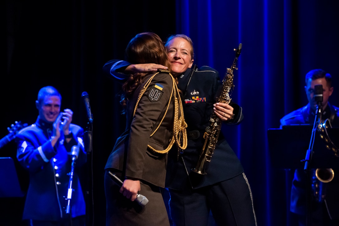 Honored Demonstration Band of the Armed Forces of Ukraine Senior Solider Anna Khabarova, left, soloist, sings with the U.S. Air Forces in Europe Ambassadors Rock Band at the Przemyskie Centrum Kultury i Nauki Zamek in Przemyśl, Poland, Oct. 20, 2022. Through music, the USAFE Band serves as a bridge to increase our cultural ties and enrich the partnerships between the U.S. and Poland. (U.S. Air Force photo by Senior Airman Jennifer Zima)