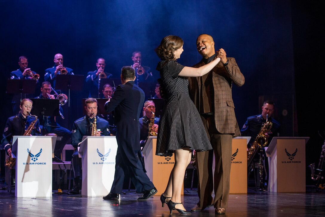 Airman musicians dance in front of the USAFE Band Ambassador's during a Swing concert.