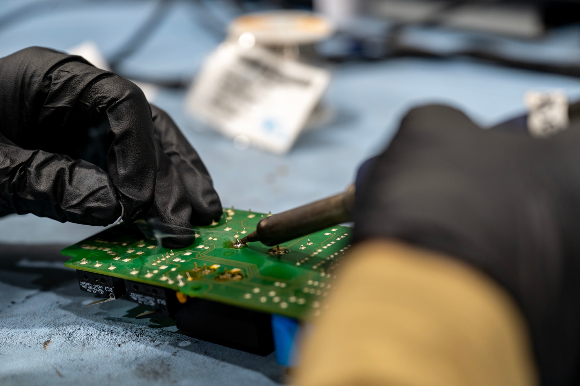 U.S. Air Force Senior Airman Joseph Besko, Avionics and Air Force Repair Enhancement Program technician, solders a computer chip at an undisclosed location within the U.S. Central Command area of responsibility, Jan. 16, 2024. AFREP plays a vital role in sustaining aircraft readiness, promoting operational effectiveness, and strategically optimizing resources within the Air Force. (U.S. Air Force Staff Sgt. Lawrence Sena)