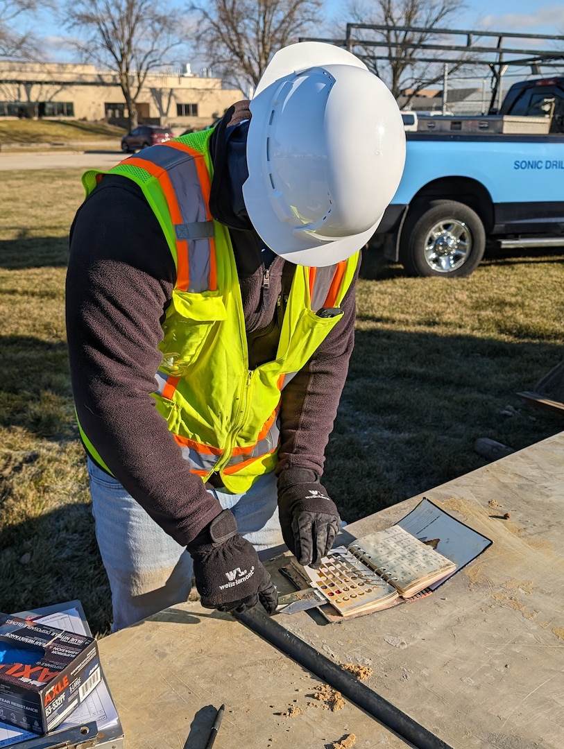 A geologist with EA Engineering, Science, and Technology, Inc. reviews a core sample from a sonic drilling rig during a remedial investigation into the presence of Per- and Polyfluoroalkyl substances at Truax Field in Madison, Wisconsin, Dec. 12, 2023. The investigation marks the second major step in the Environmental Protection Agency’s Comprehensive Environmental Response, Compensation, and Liability Act process which will guide the mitigation of PFAS compounds on and around the Air National Guard installation. (U.S. Air National Guard photo by Senior Master Sgt. Paul Gorman)