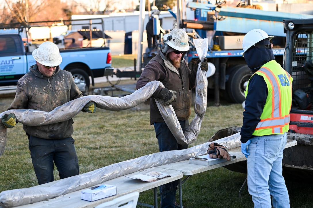 Employees of Traut Companies and a geologist with EA Engineering, Science, and Technology, Inc. prepare a core sample for analysis during a remedial investigation into the presence of Per- and Polyfluoroalkyl substances at Truax Field in Madison, Wisconsin, Dec. 13, 2023. The investigation marks the second major step in the Environmental Protection Agency’s Comprehensive Environmental Response, Compensation, and Liability Act process which will guide the mitigation of PFAS compounds on and around the Air National Guard installation. (U.S. Air National Guard photo by Isabella Jansen)