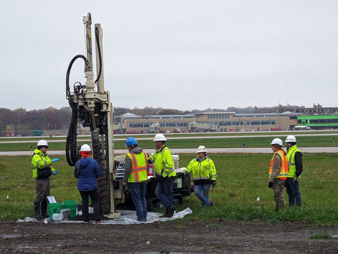 Members of the 115th Fighter Wing Civil Engineering Squadron oversee the lysimeter installation process during a remedial investigation into the presence of Per- and Polyfluoroalkyl substances at Truax Field in Madison, Wisconsin, Nov. 8, 2023. The investigation marks the second major step in the Environmental Protection Agency’s Comprehensive Environmental Response, Compensation, and Liability Act process which will guide the mitigation of PFAS compounds on and around the Air National Guard installation. (U.S. Air National Guard photo by Senior Master Sgt. Paul Gorman)