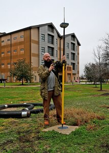 Man with testing equipment.