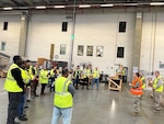 Workers gathered in a warehouse.