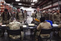 A photo of Airman going through a pre-deployment line.