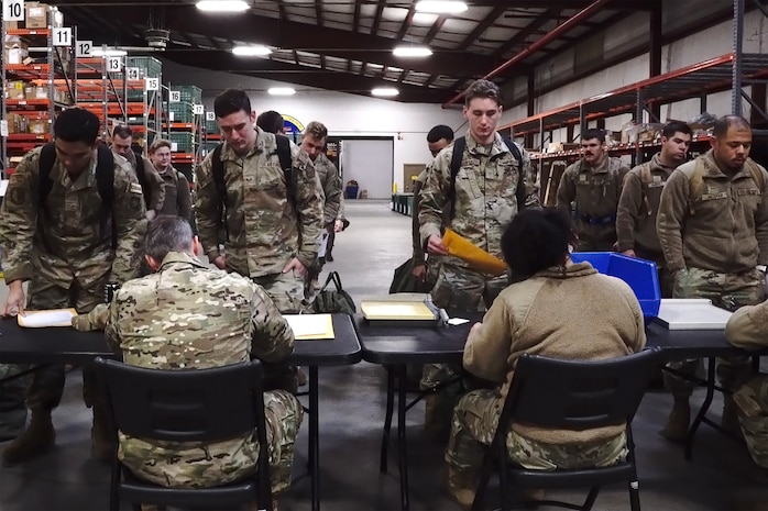 A photo of Airman going through a pre-deployment line.