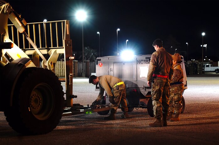 A photo of Airmen learning speed and precision while hooking up equipment.