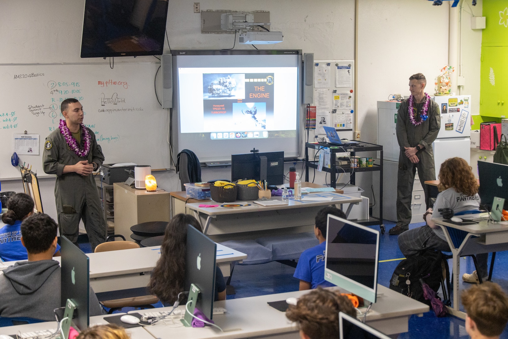 U.S. Marine Corps Cpl. Jacob Vasek and 1st Lt. Andrew Tilden with Marine Unmanned Aerial Vehicle Squadron (VMU) 3, Marine Aircraft Group 24, 1st Marine Aircraft Wing, educate students about the MQ-9A MUX/MALE at Aliamanu Middle School, Hawaii, Jan. 26, 2024. Students learned about MQ-9A capabilities and aviation career fields in the Marine Corps. (U.S. Marine Corps photo by Lance Cpl. Logan Beeney)