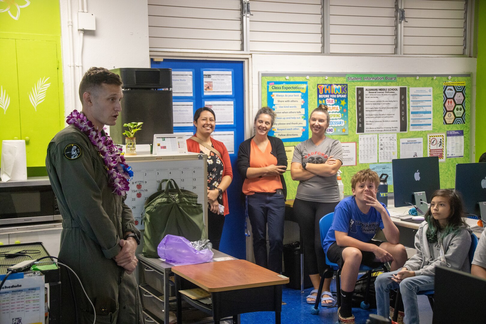 U.S. Marine Corps Cpl. Jacob Vasek and 1st Lt. Andrew Tilden with Marine Unmanned Aerial Vehicle Squadron (VMU) 3, Marine Aircraft Group 24, 1st Marine Aircraft Wing, educate students about the MQ-9A MUX/MALE at Aliamanu Middle School, Hawaii, Jan. 26, 2024. Students learned about MQ-9A capabilities and aviation career fields in the Marine Corps. (U.S. Marine Corps photo by Lance Cpl. Logan Beeney)